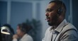 © Framestock - Modern call center office of mental health line: Close up portrait of African American hotline specialist in headset sitting at computer, listening person, providing online psychological assistance.