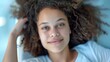 © Iuliia Metkalova - Joyful Expression: Close-Up Portrait of Smiling Woman with Curly Hair. Generative ai