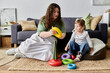 © Bliss - A plus size mother engages her daughter in a fun, colorful stacking game while sitting comfortably.