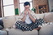 © deagreez - Photo of handsome upset man staying home feeling unwell blowing nose napkin indoors apartment room