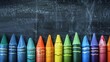 © venusvi - Multi-colored crayons lined up on a blackboard,