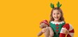 © Pixel-Shot - Cute little girl with teddy bear and Christmas pillow on yellow background with space for text