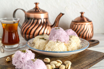 Wall Mural - Plate with tasty Turkish Pismaniye and pistachios on table