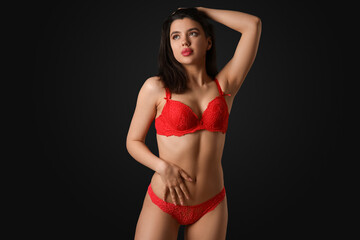 Poster - Beautiful young woman in sexy red lingerie on dark background