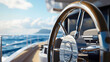 © RaeLi - A classic modern ship's steering wheel used for navigating and maneuvering a boat at sea, featuring a wooden frame and a metal center.