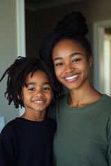 A joyful mother and son share a warm smile together at home in the morning light