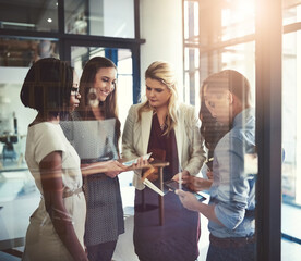 Boardroom, documents and tablet with business people meeting in office for development or planning. Discussion, diversity or smile of employee man and woman group in workplace for strategy together