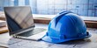 © LA Stock Vision - Professional Blue Hardhat and Laptop on Desk in Workplace Setting - Industrial Elegance and Technological Precision for Engineering Concept Design