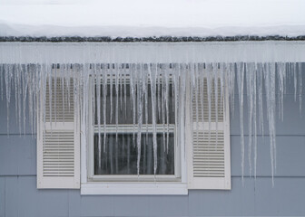 Wall Mural - winter house with icicle and snow on the roof