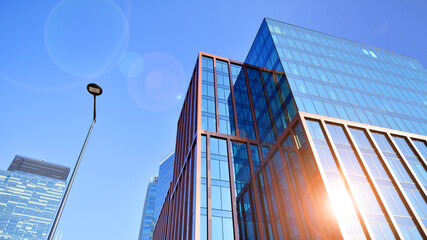 Wall Mural - Modern stylish architecture. Symmetrical blue glass building in the city. Cityscape office buildings with modern corporate architecture - business and success concept.