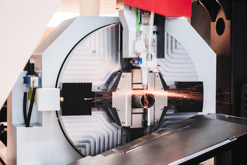 Poster - Close up scene the fiber laser cutting machine cutting  machine. cut the stainless steel tube. The hi-technology sheet metal manufacturing process by laser cutting machine. technical concept