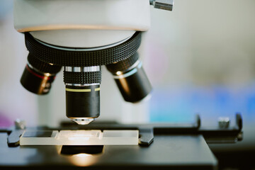 Wall Mural - Close-up image of microscope viewing microorganisms on glass slide. Emphasizing detailed view of scientific instrument in laboratory setting