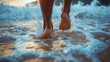 ©  Dreamy Shots - Feet running through ocean waves at sunset on a sandy beach, capturing a carefree and joyful seaside moment during a summer vacation