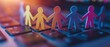 © Nattapat - Digital circle of paper people figures holding hands on a laptop keyboard, representing virtual support, community connection, and social bonds in an online environment