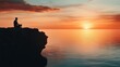 © ProStockGallery - Silhouette of Man Meditating on Cliff at Sunset Over Ocean.
