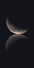 Wall Mural - waning crescent moon at 37 point 4 percent illumination on black background with rippled reflection