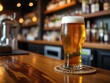 © Desmond - A pint glass of beer with foam cap sitting on a bar counter