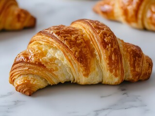 The croissant flaky and buttery, with a perfectly crisp exterior and a soft, layered interior.