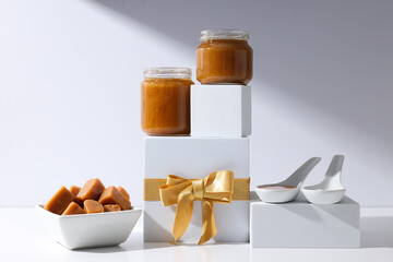 Wall Mural - Salted caramel in a jar with a gift