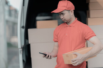 A person wearing a red T-shirt is delivering a package to a satisfied customer. friendly staff High quality delivery service with cardboard boxes delivering parcels to customers.