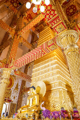 Wat Phra That Nong Bua, Ubon Ratchathani, inside there is the Phra That Sri Maha Bodhi Chedi, a replica of the Chedi in Bodh Gaya, India, stucco sculptures, candles, and two large Naga statues.