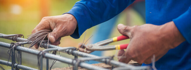 Banner Construction Worker hands using pincer pliers iron wire. Outdoor Worker using wire bending pliers. Banner Men hands bending cutting steel wire fences bar concrete worker with copy space