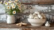 © Aziz - A white ceramic bowl filled with garlic cloves, a white ceramic pitcher with daisies, and two pieces of ginger root sit on a rustic wooden table.
