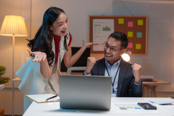 Young business team Young Asian woman discussing real estate project on tablet, laptop sitting at desk in office Two colleagues of professional business people working together teamwork concept.