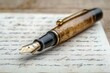 © Lubos Chlubny - Elegant fountain pen resting on handwritten letter on wooden table