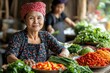 Southeast asian woman selling fresh vegetables at local market
