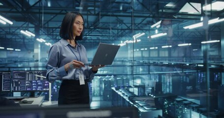Poster - Asian Software Developer Analyze System Performance Metrics on a Laptop Inside a Modern Data Center. Young Female Manager Ensuring Efficient Operations for Critical Infrastructure