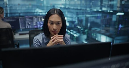 Poster - Beautiful Asian Female IT Engineer, Surrounded by Office Equipment, Studies Her Computer Display in a Modern Data Center, Reviewing System Health and Ensuring Optimal Server Operations