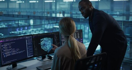 Poster - In a Data Center Office, a Female Software Developer Focuses on an AI Model Displayed Across Her Monitors, as a Black Colleague Stands Nearby, Offering Insightful Input for Their Project