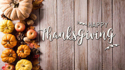 Wall Mural - autumn and thanksgiving composition. pumpkin, cotton flowers and autumn leaves on dark wooden backgr