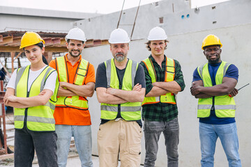 Group of workers teamwork in construction industrial plant. Diverse workers standing arm crossed together. Happy Industrial engineer people team concept.