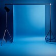 © openphoto - Modern, minimalist blue photography studio with empty product display platform and spotlight setup, ideal for clean, vibrant product showcases