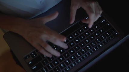 Leinwandbilder - This image features a closeup shot that captures hands actively typing on a laptop keyboard, illuminated by low light, reflecting the essence of modern work, creativity, and professional efficiency