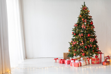 Wall Mural - Christmas tree with gifts decorated with toys in the interior for the new year