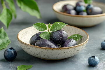 Wall Mural - Photo - Fresh Blueberries with Green Leaves in a Bowl