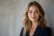 © Imagentive - Confident Young Businesswoman in Blazer, Smiling Headshot