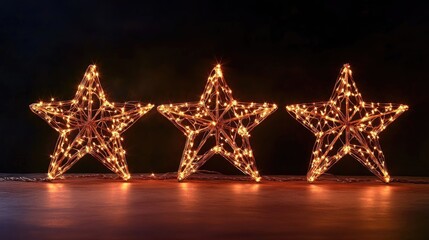 Wall Mural - three luminous stars against a dark backdrop creating a radiant festive star shaped light display