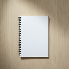 A blank spiral notebook on a wooden surface under a light shadow.