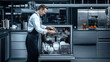 © Alfazet Chronicles - Chef arranging dishes in a commercial kitchen dishwasher, surrounded by sleek stainless steel counters and modern kitchen equipment, showcasing a professional kitchen environment.