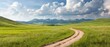 © Janis - A dirt path traverses a expansive, grass-covered field against the backdrop of distant mountain ranges Clouds populate the heavens above