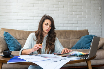 Side hustle. Young architecture and urbanism university student woman freelance work as side job as interior designer working at home with client using laptop computer for communication and video call