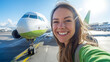© Erwin - A cheerful young caucasian woman in a green outfit smiling widely in front of an airplane on the runway, set on embarking on her exciting journey, eager for exploration.