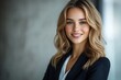 © Imagentive - Smiling Businesswoman with Long Wavy Blonde Hair in Office