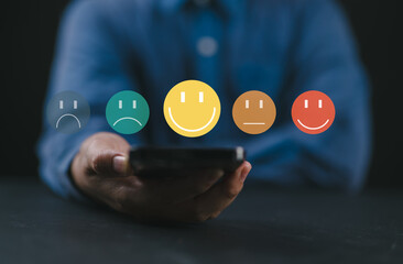 Poster - Customer satisfaction survey via online application, customers use smartphones to express their feedback with emoticons ranging from happy to sad, providing the best service and product quality.
