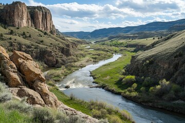 Poster - A winding river flows through a canyon, with steep cliffs and lush vegetation.