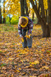 © yanadjan - Senior woman in autumn park. Selective focus.